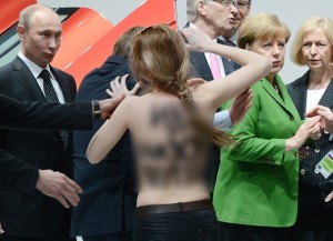 A topless demonstrator with a message on