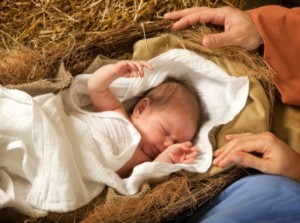 20 days old baby sleeping in a christmas nativity crib