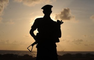 Sri Lankan army soldiers stand guard on