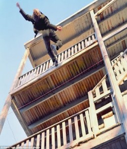 woman falling off building