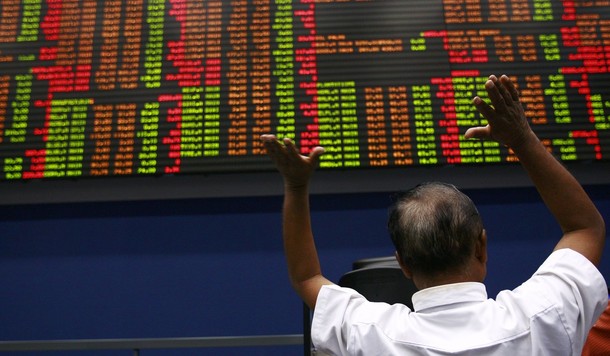 An investor reacts while speaking with a broker at the Colombo Stock Exchange in Colombo