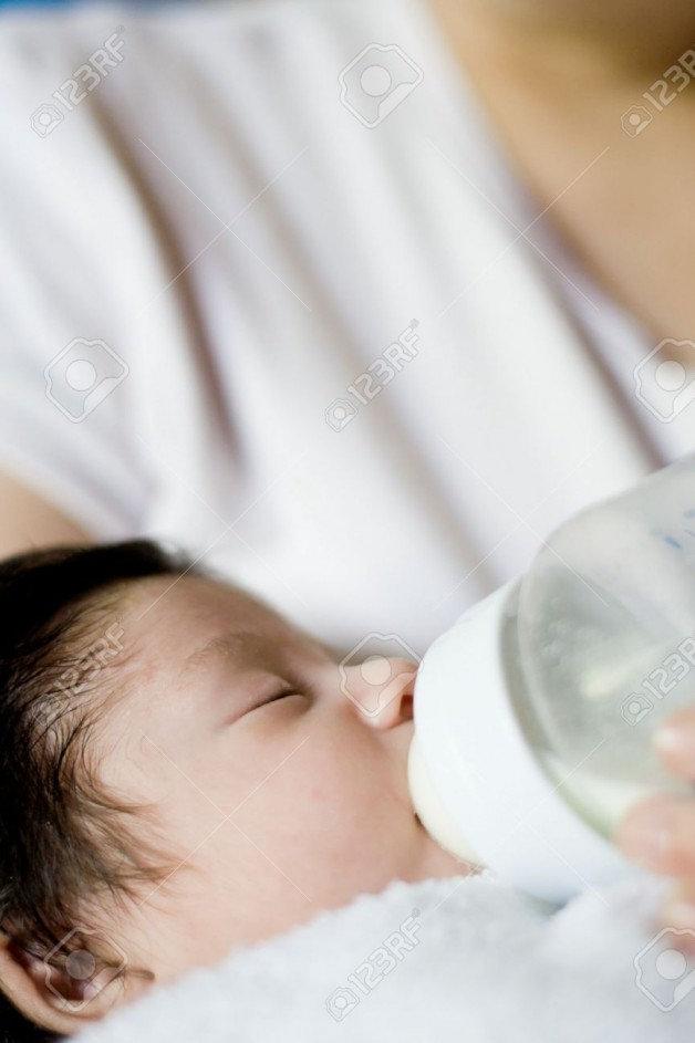 3967587-cute-baby-boy-drinking-from-a-milk-bottle-Stock-Photo