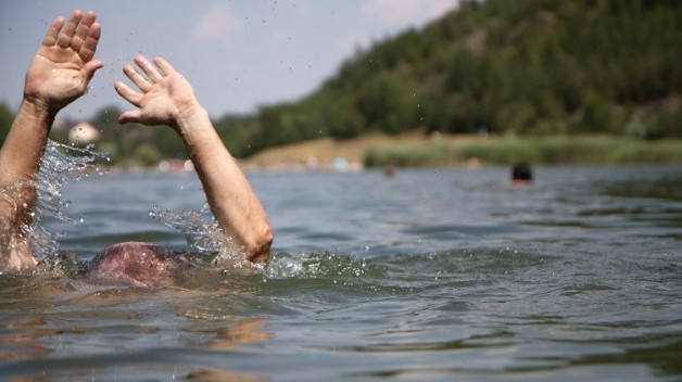 Drowning swimmer at a lake in summer