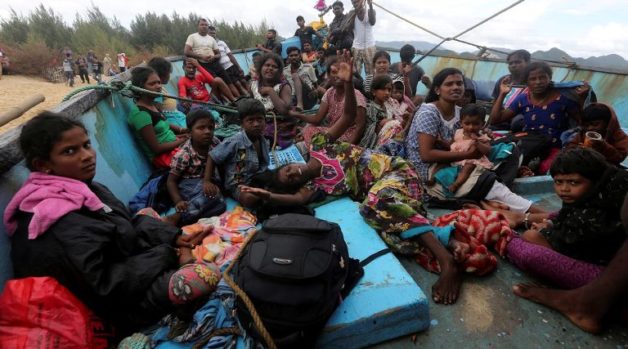 Some of more than forty Sri Lankan migrants wait on board a boat after it was beached to receive supplies and fuel off the coast of Lhoknga, near Banda Aceh in Aceh province, Indonesia June 14, 2016 in this photo taken by Antara Foto. Antara Foto/Irwansyah Putra/via REUTERS ATTENTION EDITORS - THIS IMAGE HAS BEEN SUPPLIED BY A THIRD PARTY. FOR EDITORIAL USE ONLY.  MANDATORY CREDIT. INDONESIA OUT. NO COMMERCIAL OR EDITORIAL SALES IN INDONESIA.
