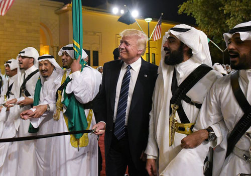 US President Donald Trump joins dancers with swords at a welcome ceremony ahead of a banquet at the Murabba Palace in Riyadh on May 20, 2017. / AFP PHOTO / MANDEL NGAN        (Photo credit should read MANDEL NGAN/AFP/Getty Images)